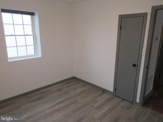 unfurnished room featuring dark hardwood / wood-style floors