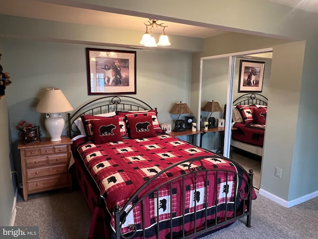 carpeted bedroom with a closet and baseboards