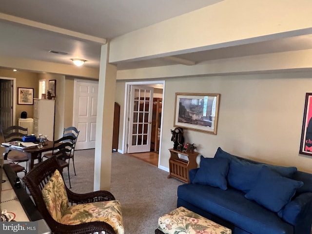 living room featuring visible vents and carpet flooring