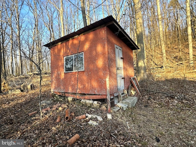 view of home's exterior with an outdoor structure