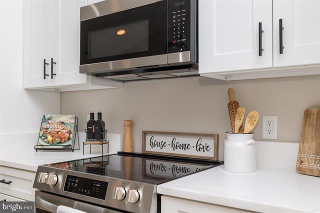 kitchen with stainless steel appliances and white cabinets