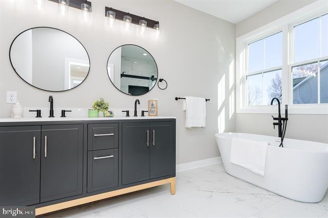 bathroom with vanity and a bathtub