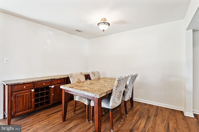 dining area featuring dark hardwood / wood-style floors