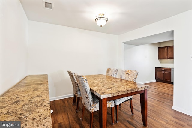 dining area with dark wood-type flooring