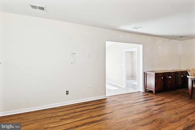 unfurnished room with dark hardwood / wood-style floors