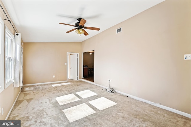 carpeted empty room featuring ceiling fan and lofted ceiling