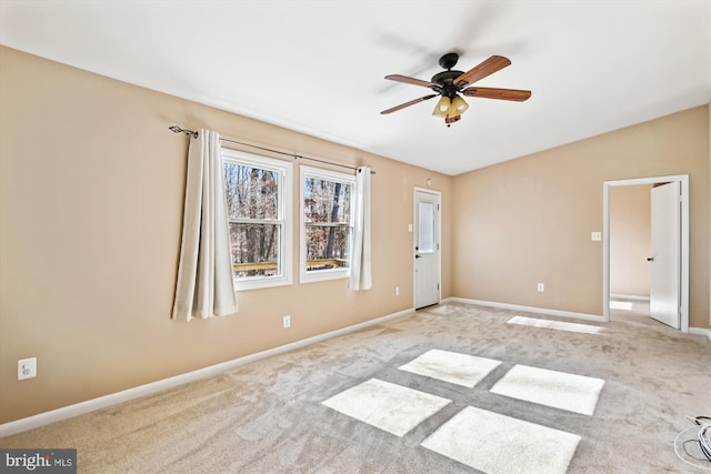 carpeted spare room with ceiling fan