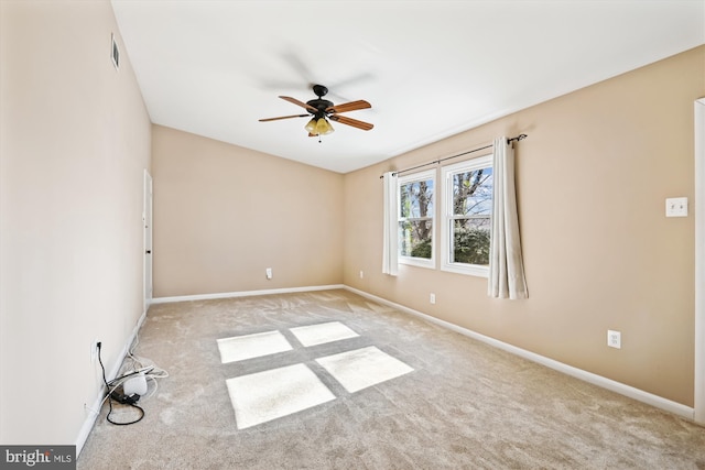 spare room with light colored carpet and ceiling fan