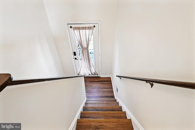 stairs featuring hardwood / wood-style flooring