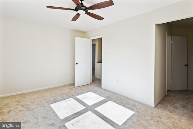 unfurnished bedroom featuring light colored carpet and ceiling fan