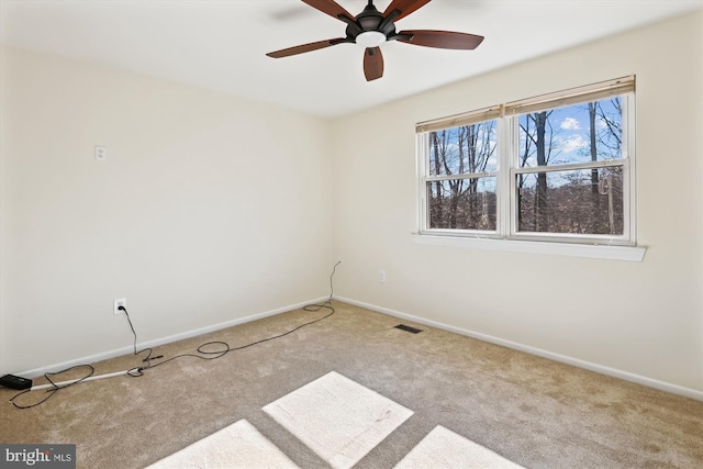 unfurnished room featuring light colored carpet and ceiling fan