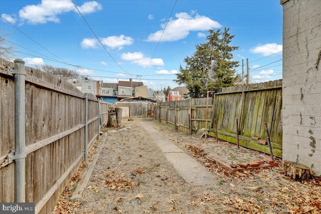 view of yard featuring a residential view and a fenced backyard