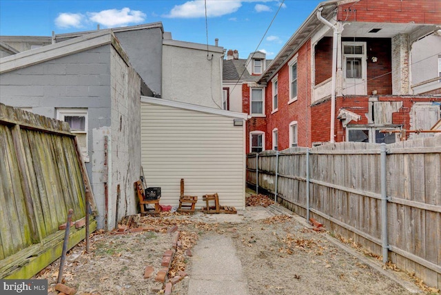 back of property featuring a fenced backyard