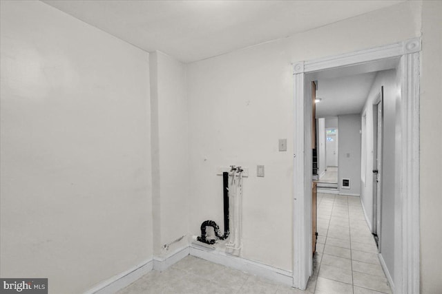 washroom with baseboards and light tile patterned flooring