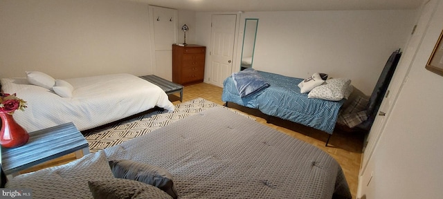 bedroom with light parquet flooring