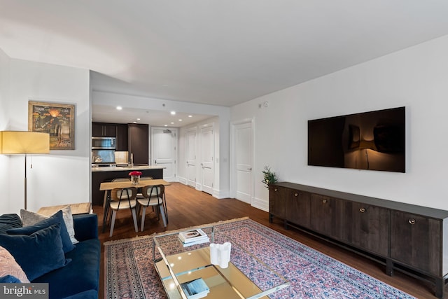 living room with dark hardwood / wood-style flooring