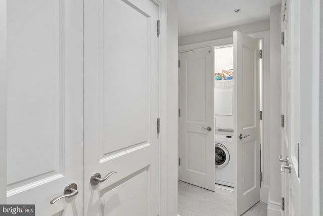 laundry area featuring stacked washer and dryer