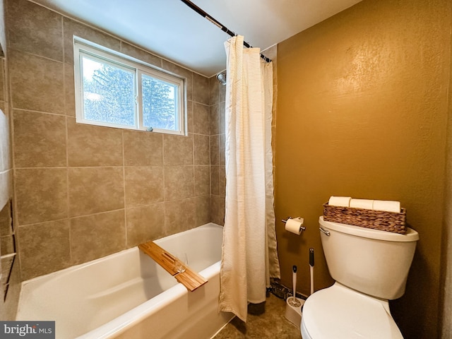 bathroom with shower / tub combo with curtain and toilet