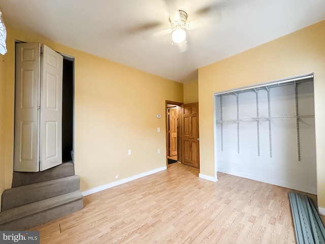 unfurnished bedroom with ceiling fan, a closet, and light wood-type flooring