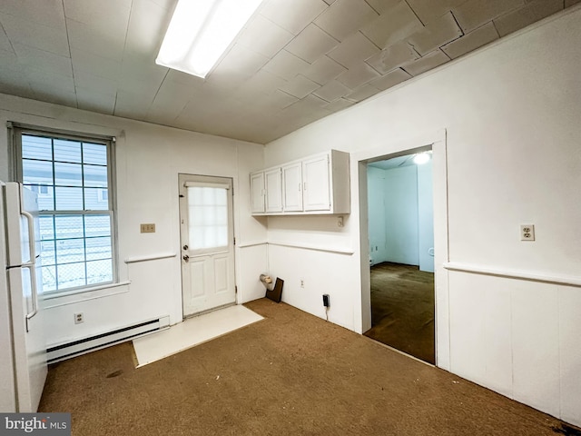 laundry area featuring a baseboard heating unit and dark colored carpet