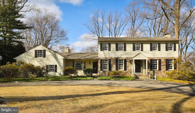 colonial-style house with a front yard