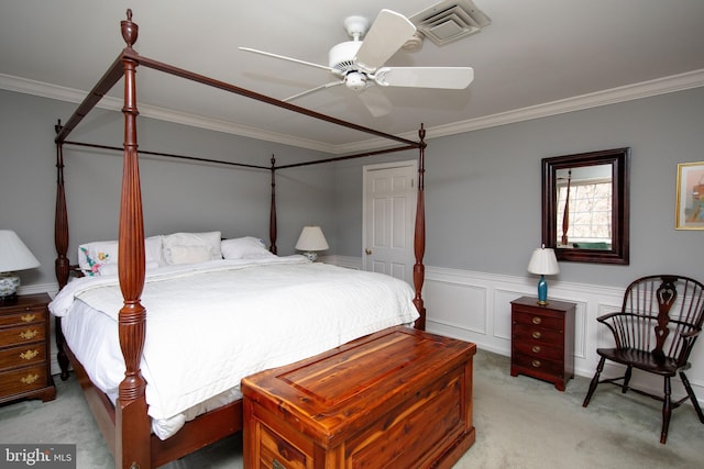 bedroom featuring ornamental molding, light colored carpet, and ceiling fan