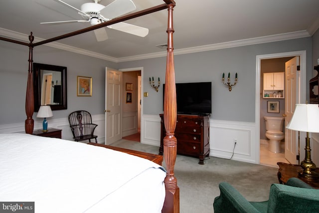 carpeted bedroom featuring crown molding, connected bathroom, and ceiling fan