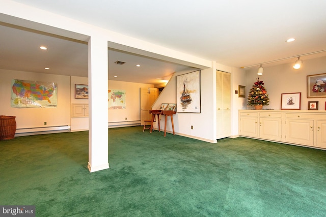 interior space with a baseboard heating unit, dark carpet, and rail lighting