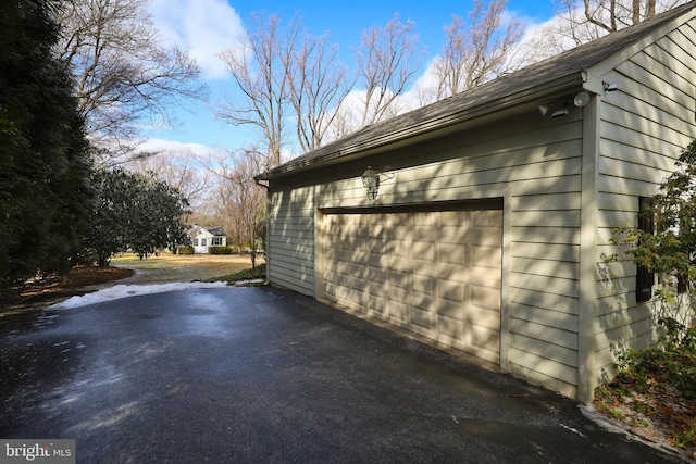 view of side of property featuring a garage and an outdoor structure