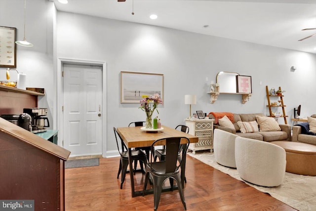 dining area with wood-type flooring and ceiling fan