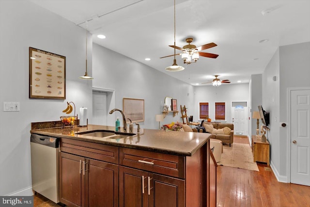 kitchen with sink, ceiling fan, decorative light fixtures, stainless steel dishwasher, and light wood-type flooring