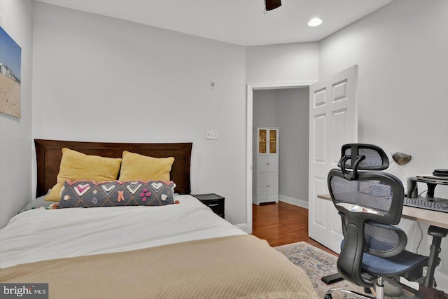 bedroom with dark wood-type flooring and ceiling fan