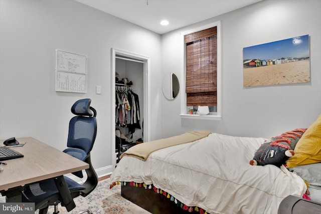 bedroom with hardwood / wood-style floors and a closet