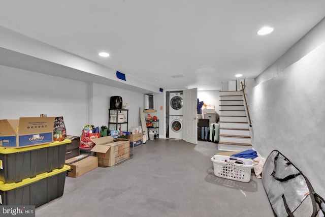 basement featuring stacked washer / dryer