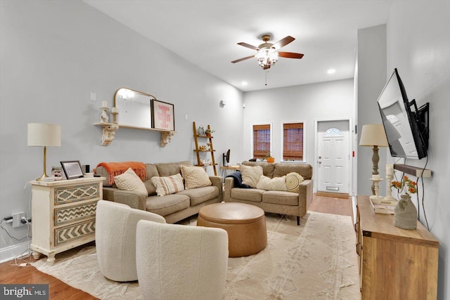 living room with ceiling fan and light hardwood / wood-style flooring