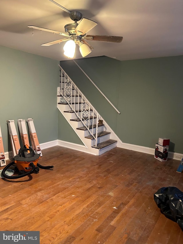 stairway featuring hardwood / wood-style flooring and ceiling fan