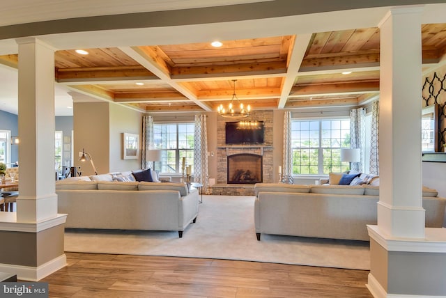 living room featuring an inviting chandelier, wood-type flooring, decorative columns, and wooden ceiling