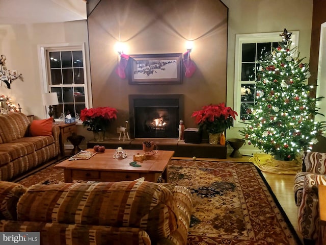 living room with a lit fireplace