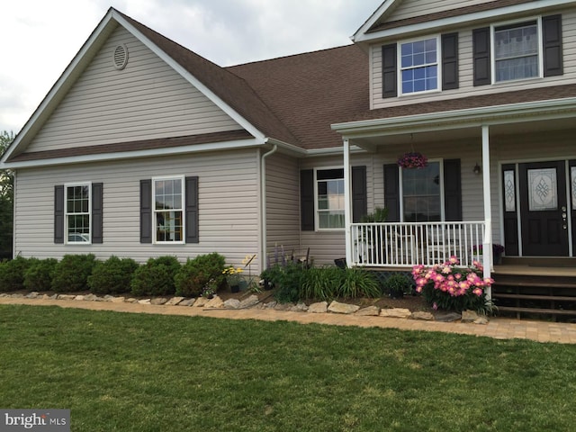 view of front of home featuring a porch and a front lawn