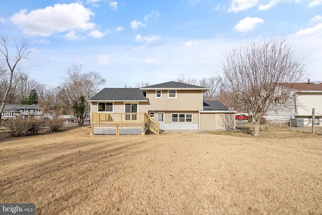 back of house with a wooden deck, a lawn, and central air condition unit