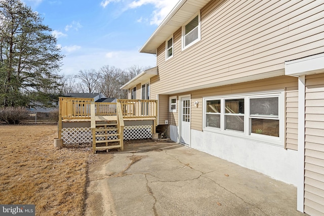 exterior space with a wooden deck and a patio