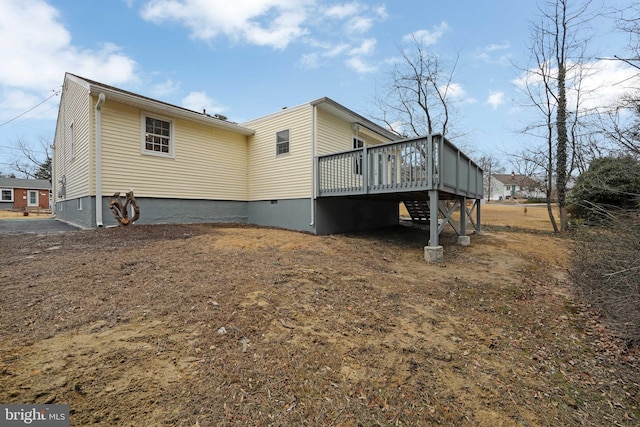 rear view of property featuring a wooden deck