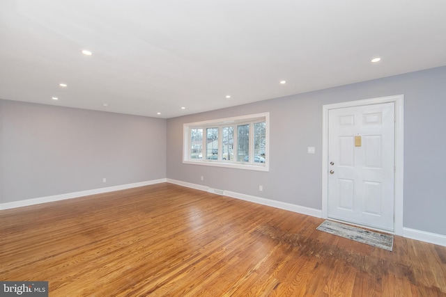 foyer entrance with light hardwood / wood-style floors