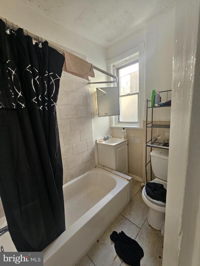 full bathroom with shower / bath combination with curtain, vanity, toilet, and tile patterned flooring