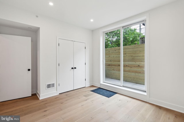 interior space featuring a closet, access to exterior, and light hardwood / wood-style flooring