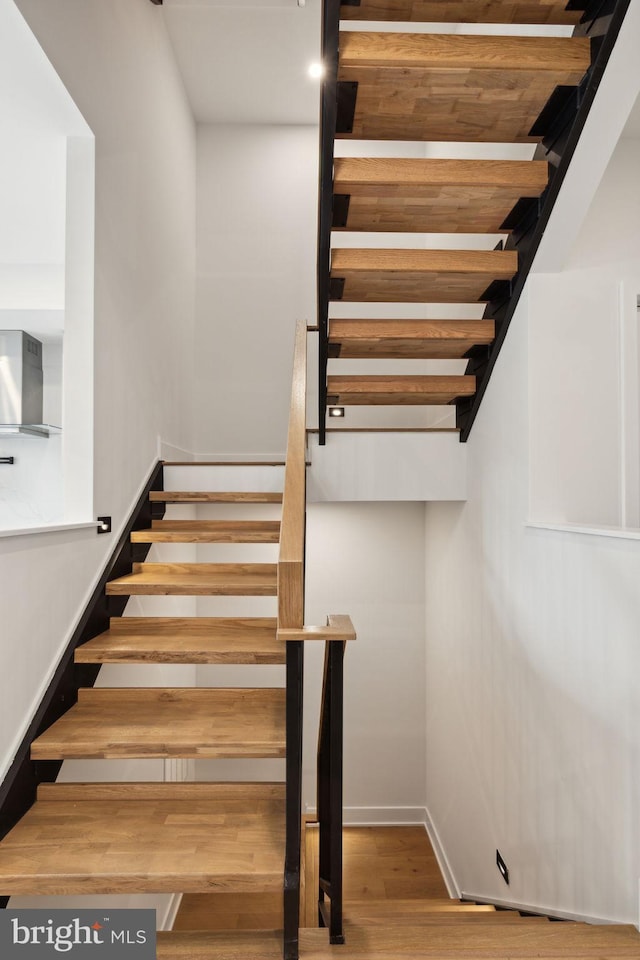 stairs with wood-type flooring