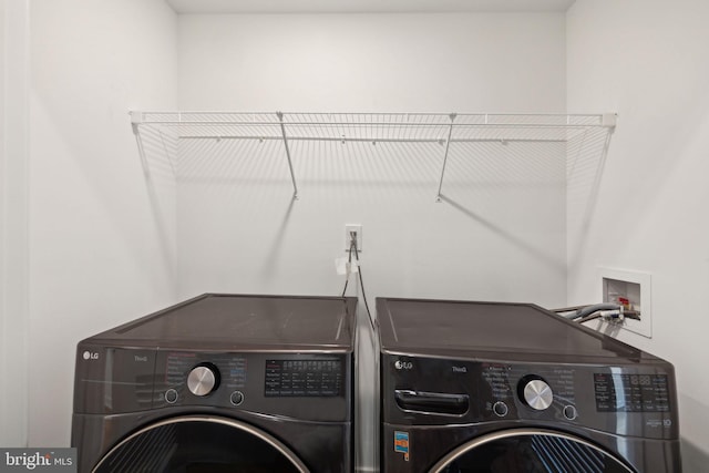 clothes washing area with washer and dryer