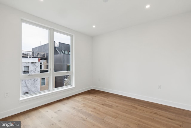 unfurnished room with light wood-type flooring