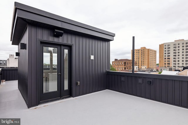 view of exterior entry featuring a balcony