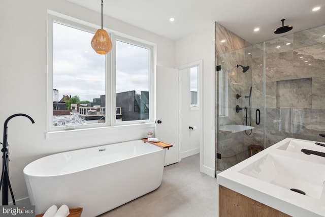 bathroom with vanity and separate shower and tub